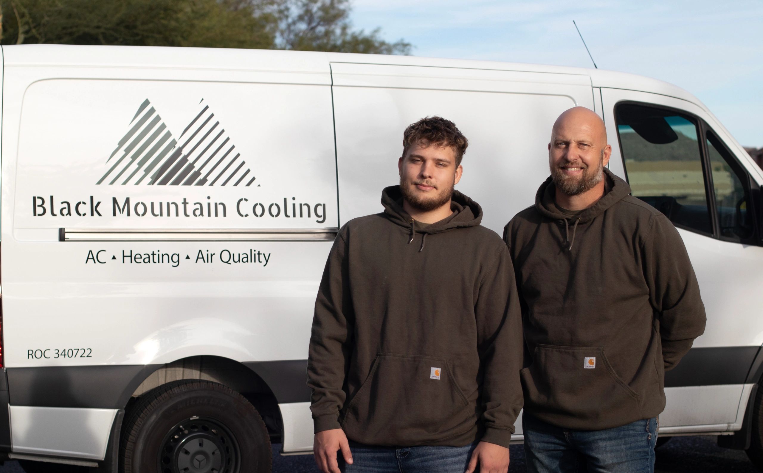 Technician servicing outdoor AC units